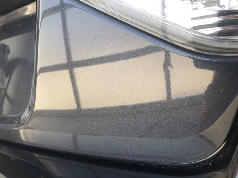 A close up of a car 's bumper and headlight