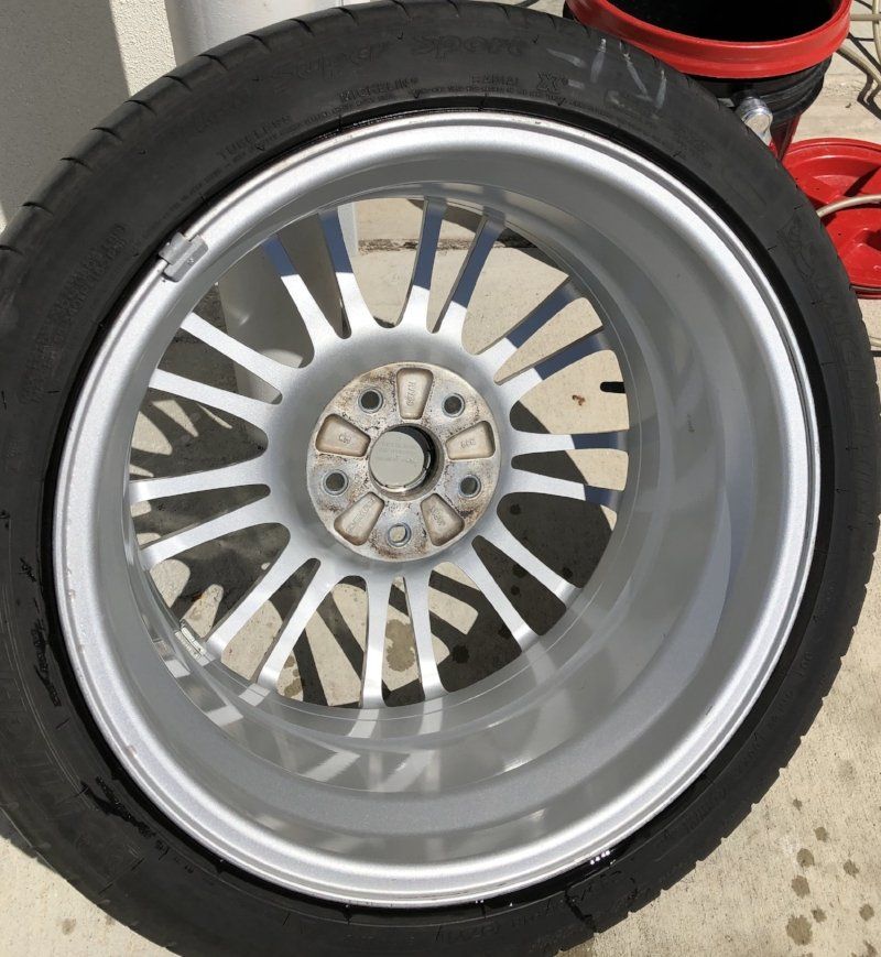 A close up of a car wheel with a tire on it