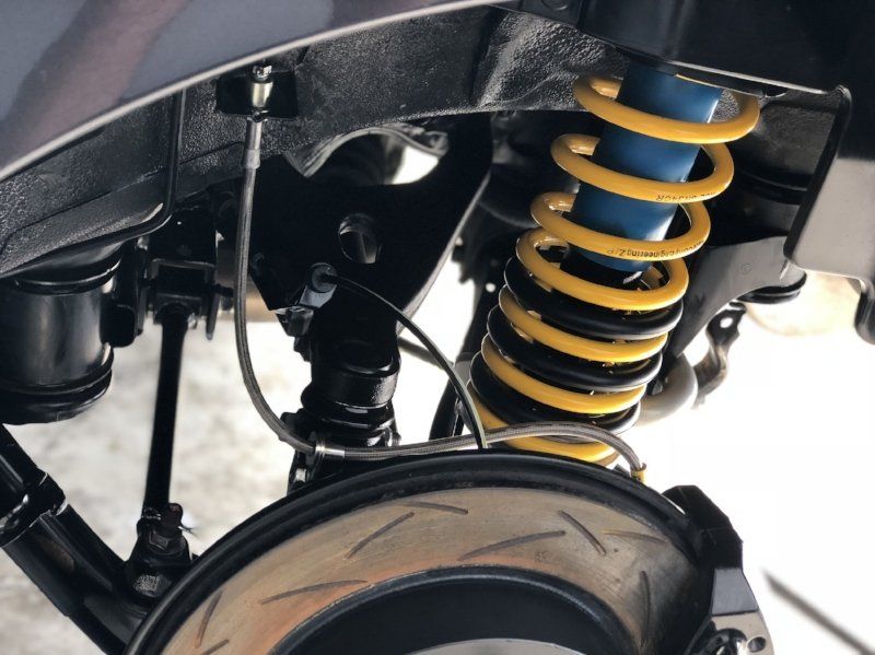 A close up of a bilstein shock absorber on a car