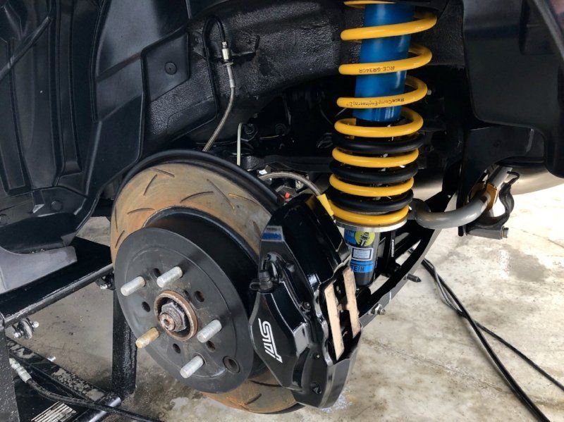 A close up of a car 's suspension and brake system