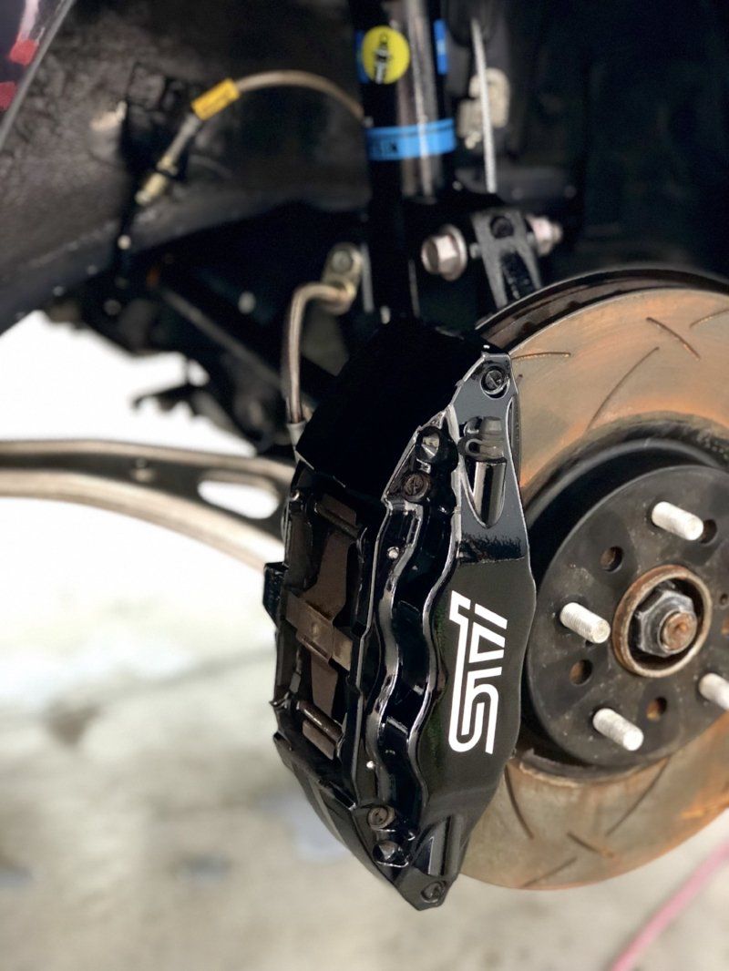 A close up of a brake caliper on a car