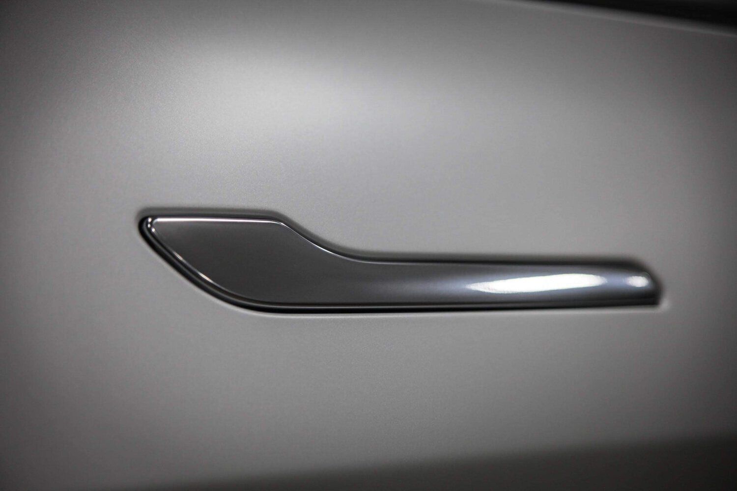 A close up of a door handle on a car door.