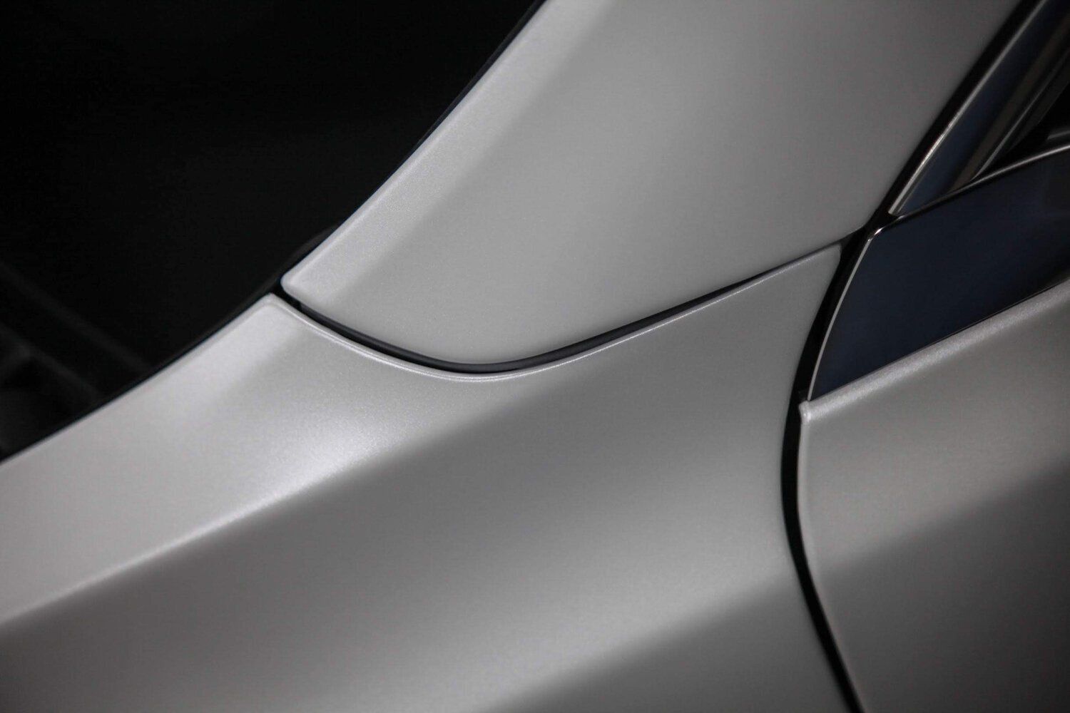 A close up of the side of a car with a black trim.