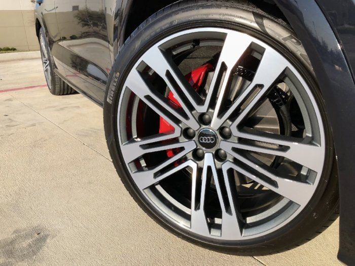 A close up of a car wheel with the word audi on it