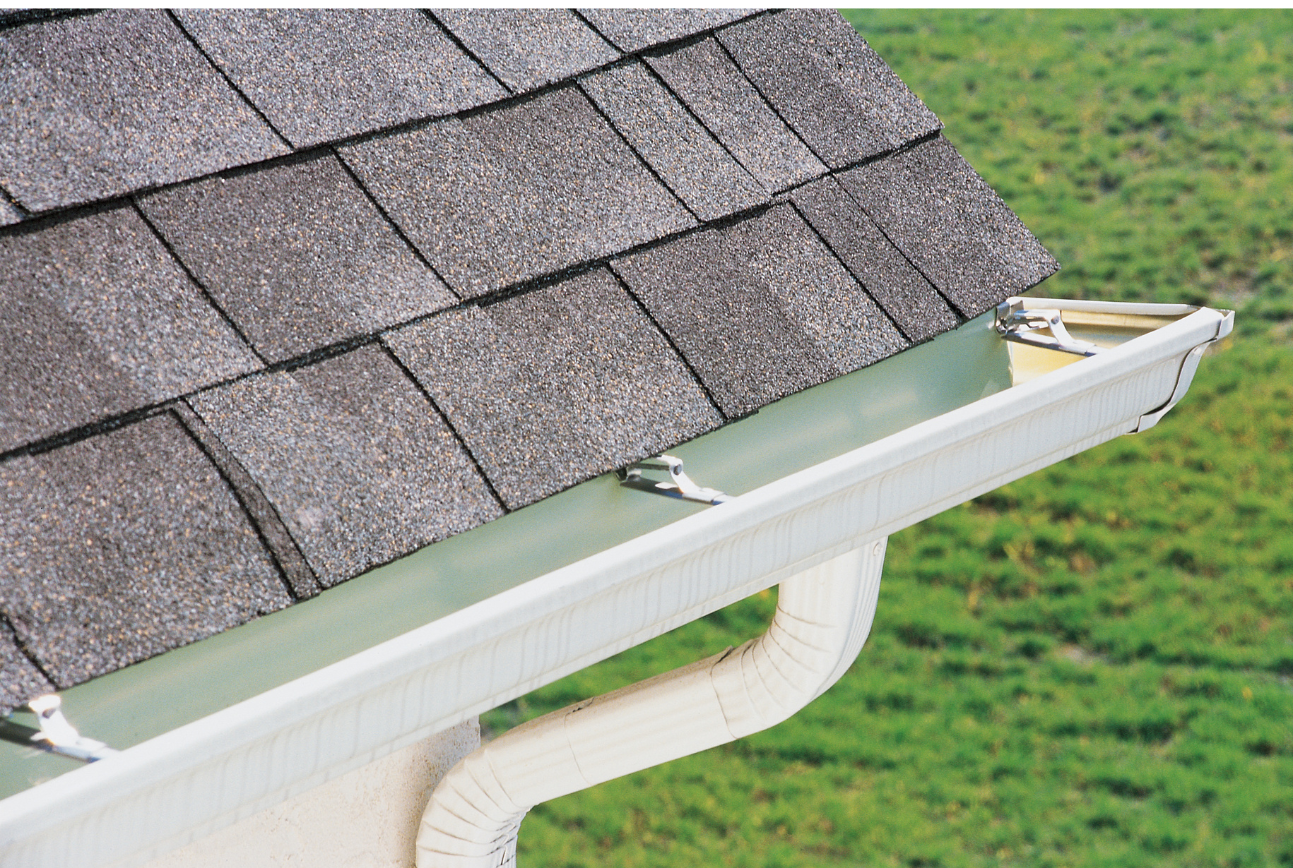 A picture of the corner of a roof with white gutters on it in Mandeville, LA.