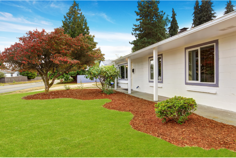 A picture of a house with landscaping in front and freshly cut grass in Mandeville, LA.