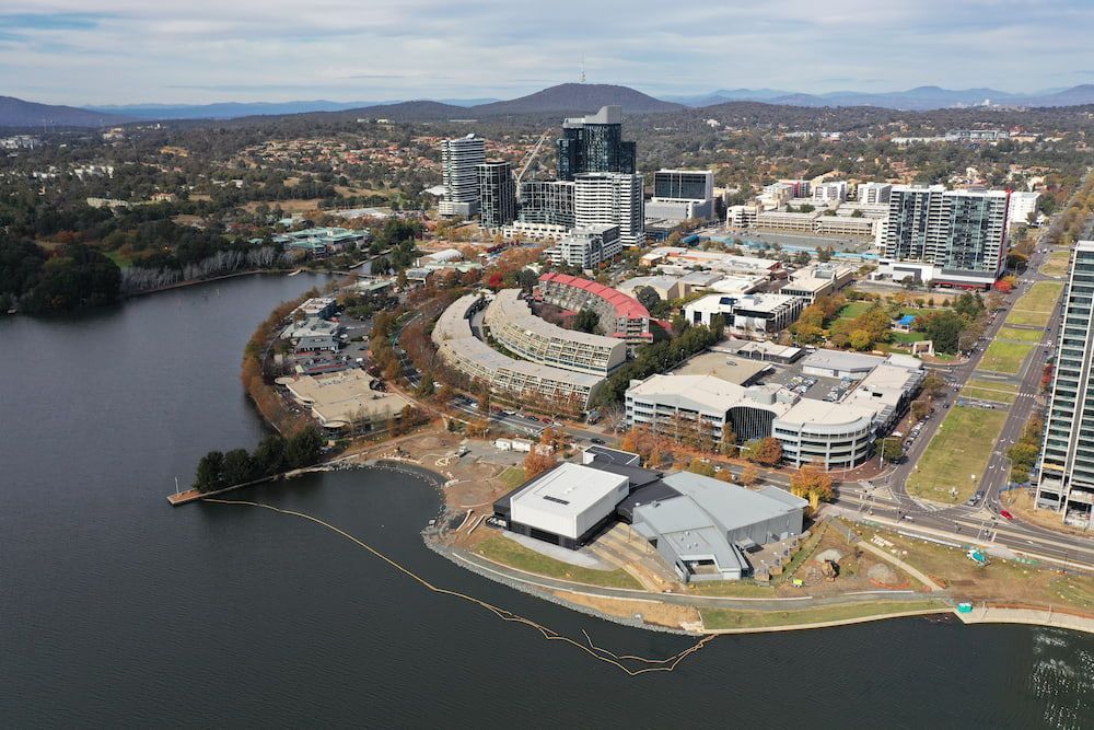 An Aerial View Of A City Surrounded By Water And Buildings — Macgregor Auto In Belconnen, ACT