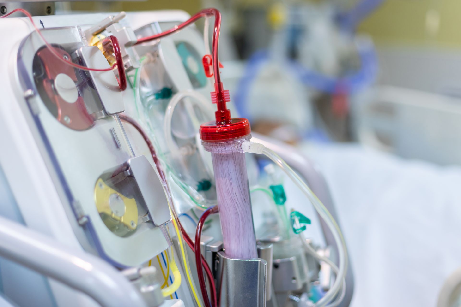 Close-up of medical tubing and equipment with red and clear IV lines in a hospital setting