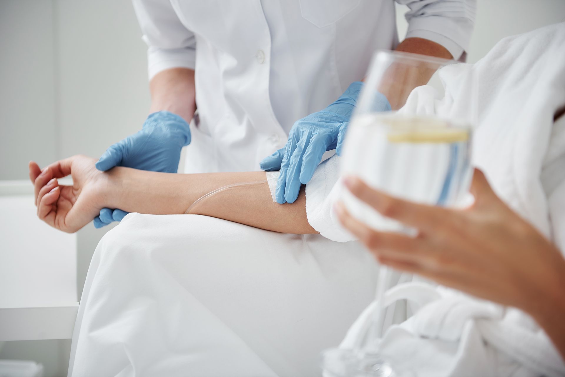 Medical staff taking a patient’s blood pressure in a hospital bed