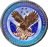 Circular blue seal with an eagle spreading its wings over a shield and starry border.