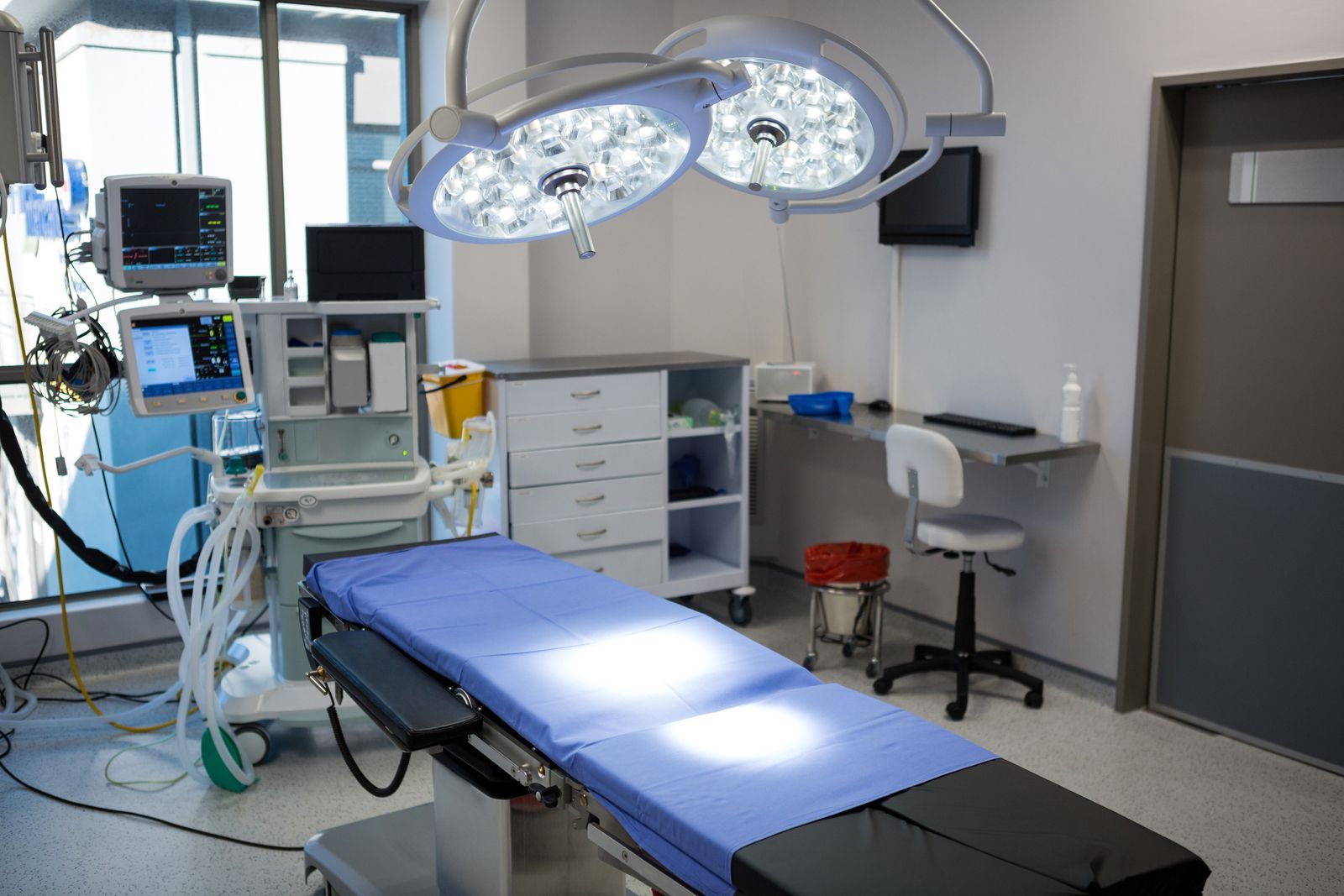 An operating room with an operating table and a monitor