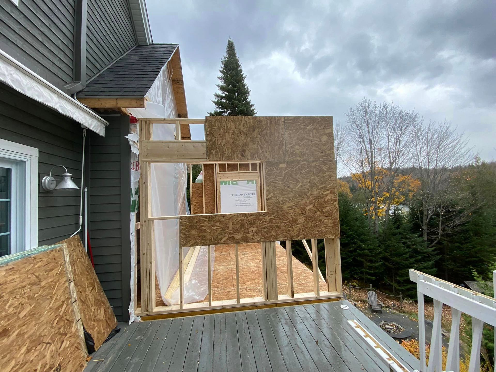 A house is being built with a wooden deck in front of it.