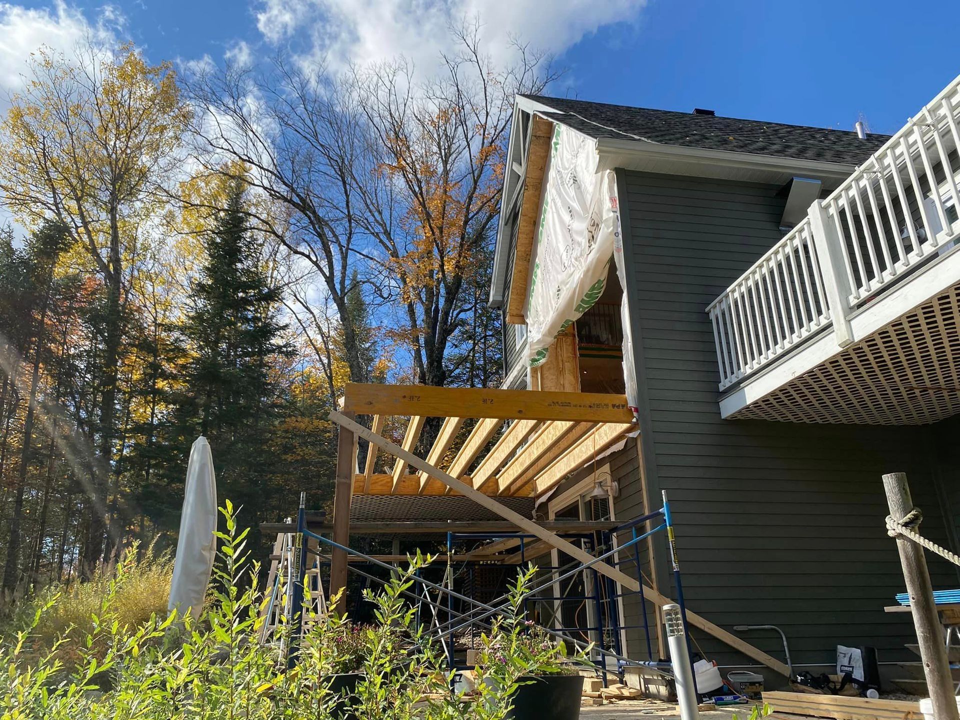 A house is being built with a deck and a balcony.