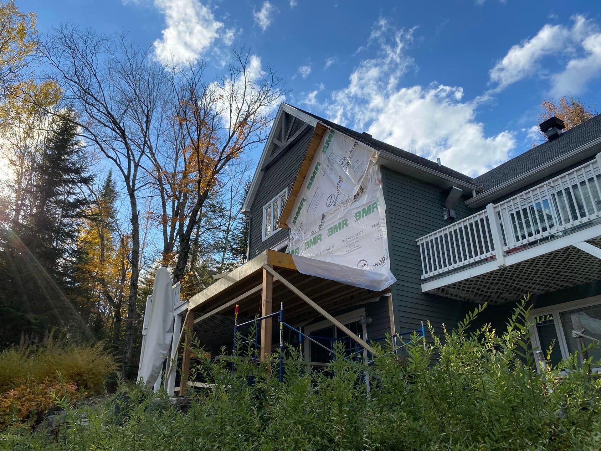 A house is being remodeled with a porch and a balcony.