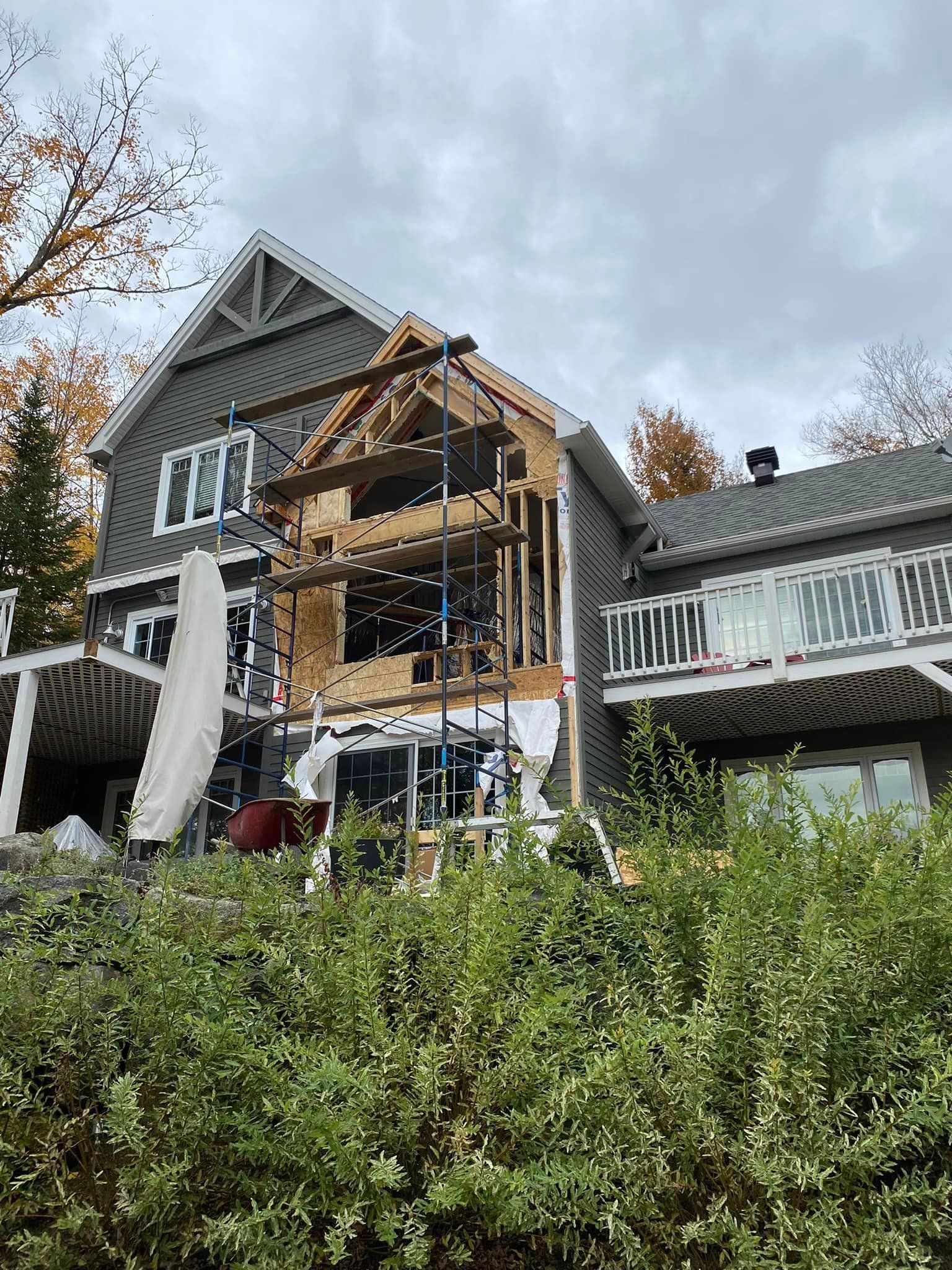 A large house is being remodeled on a hillside.