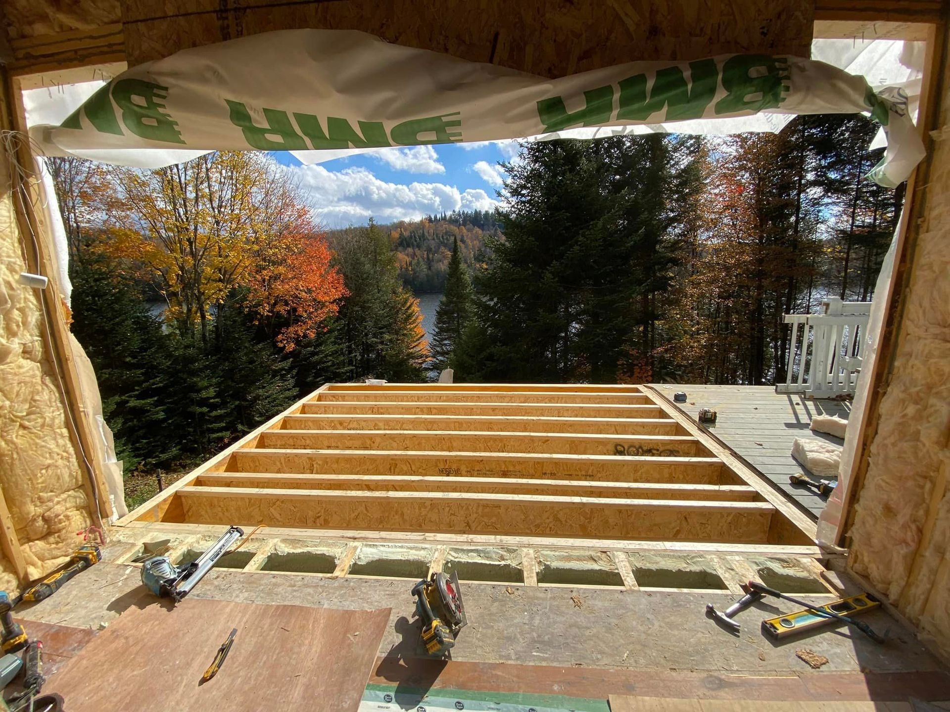 A building under construction with a view of a lake.