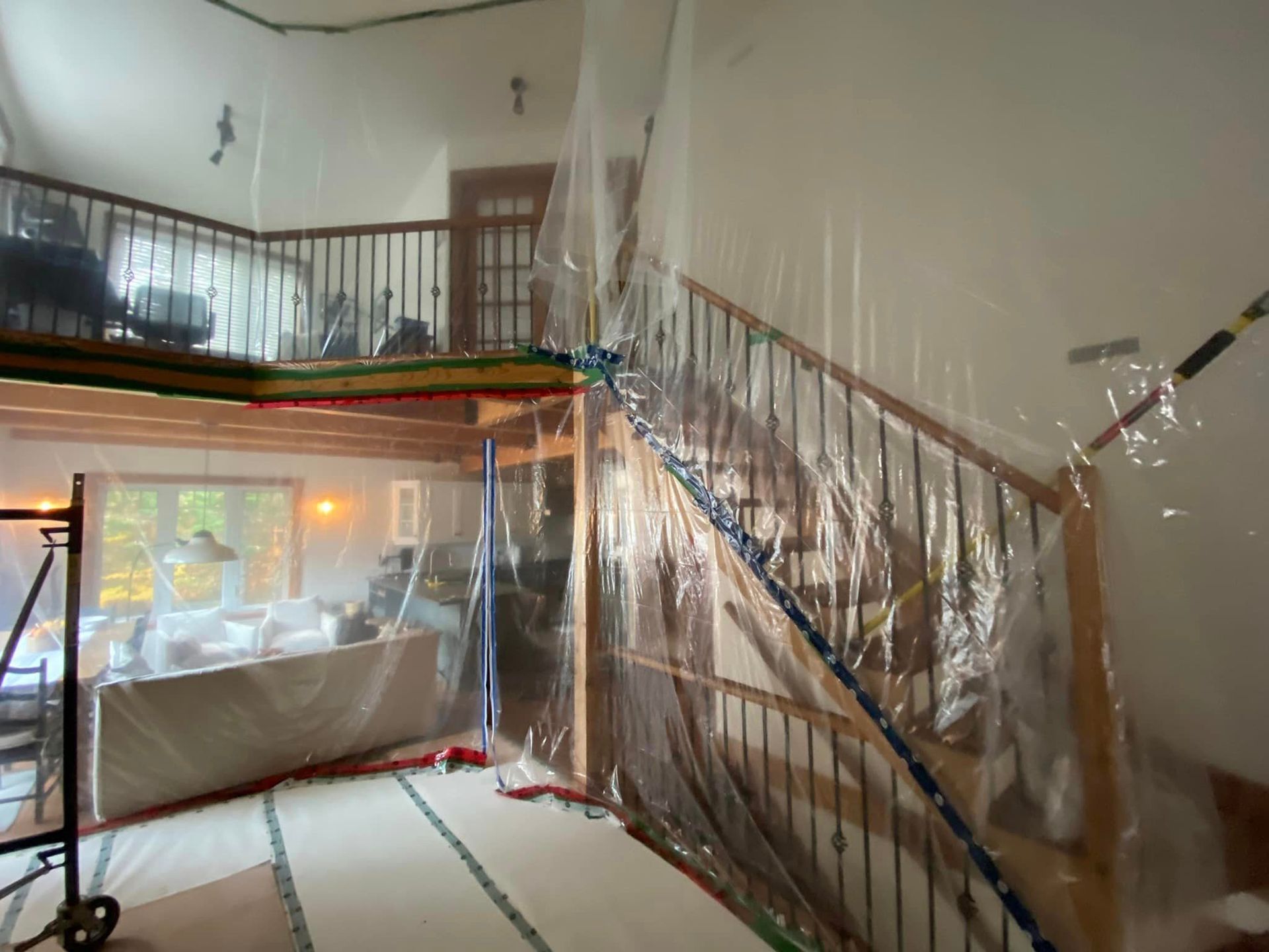 A room with a staircase covered in plastic