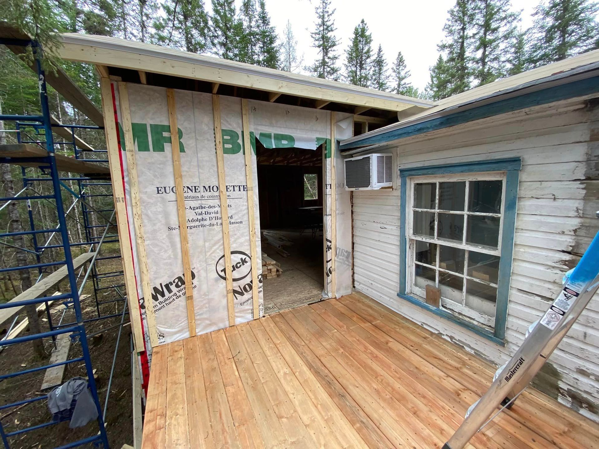 A wooden deck is being built on the side of a house.