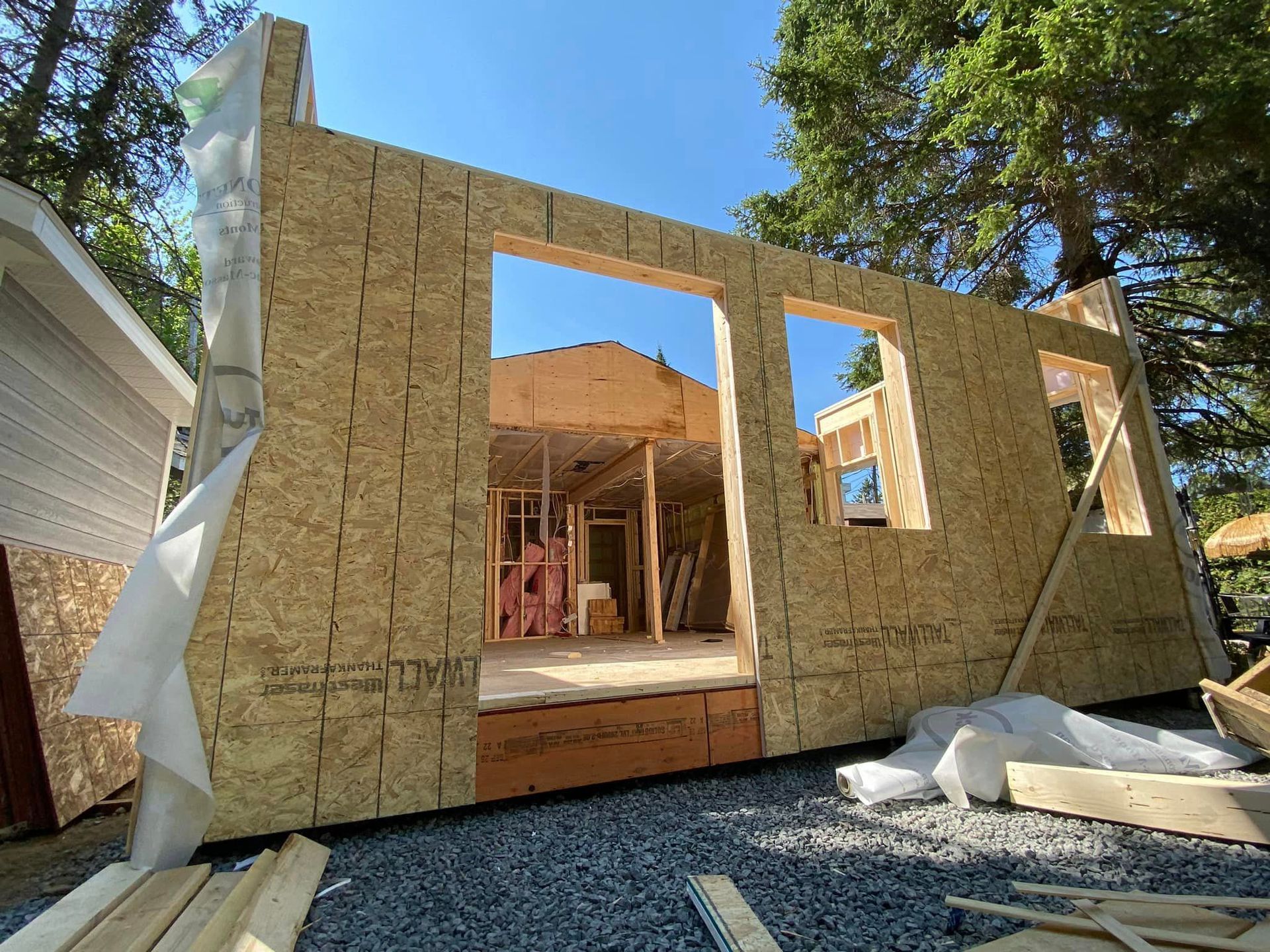 A house is being built with a lot of wood and a lot of windows.