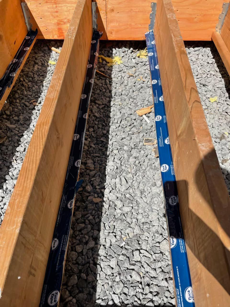 A pile of gravel is sitting on top of a wooden box.