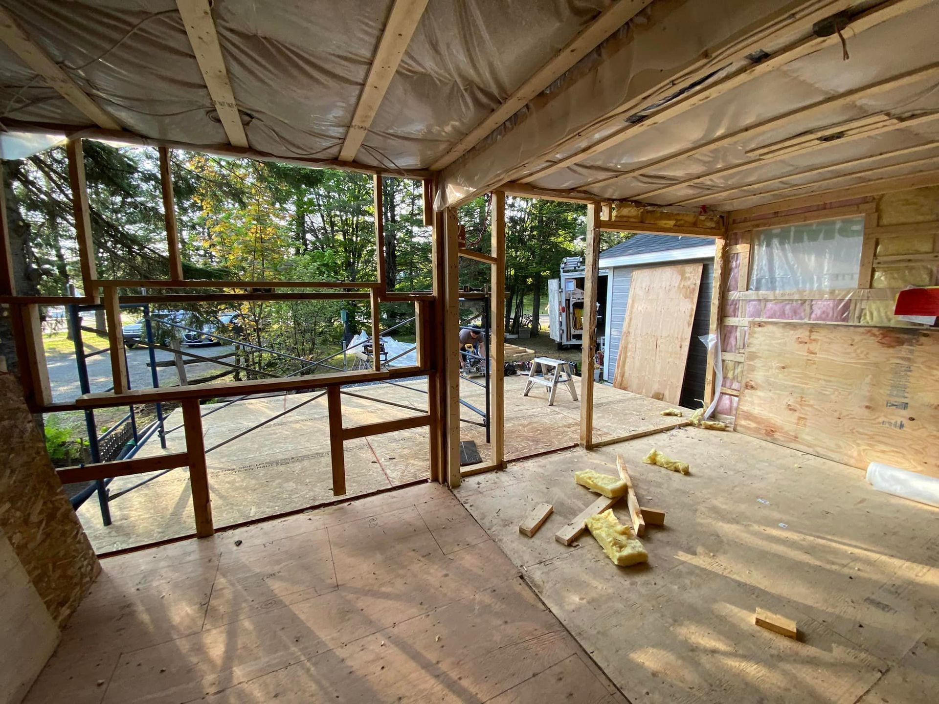A room with a lot of wooden beams and a window.