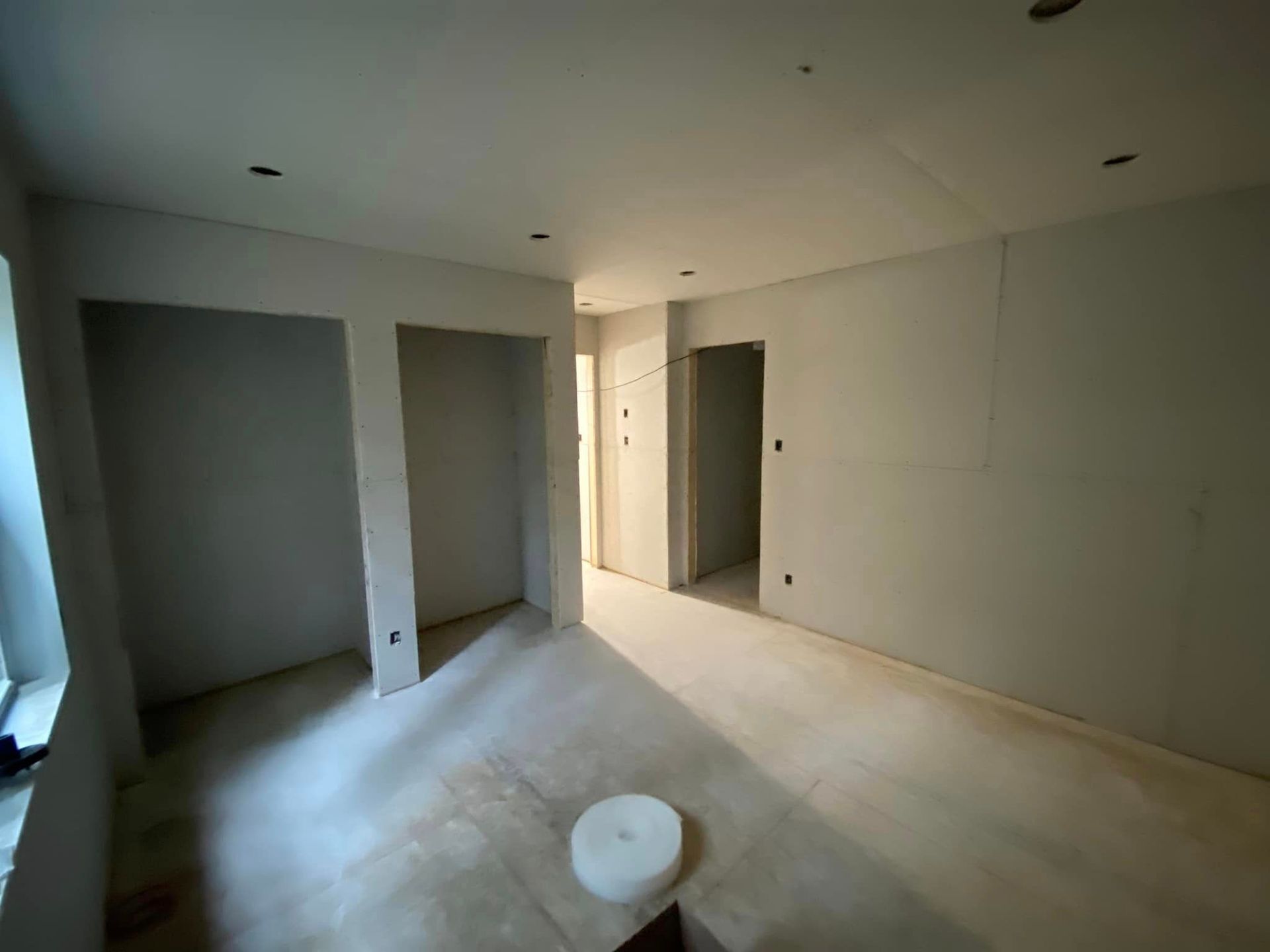 A room with a lot of drywall on the walls and floor.