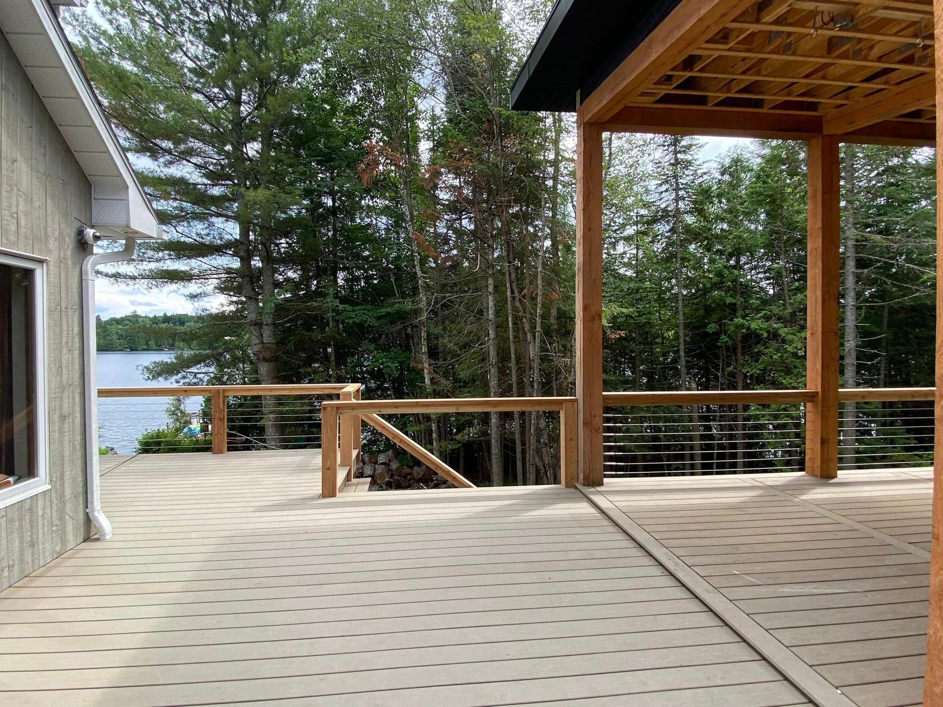 A deck with a view of a lake and trees