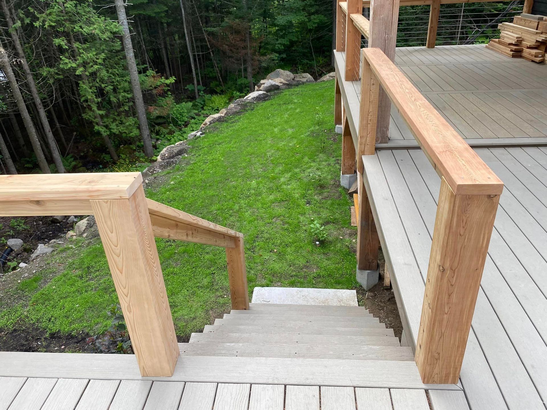 A wooden deck with stairs leading up to it