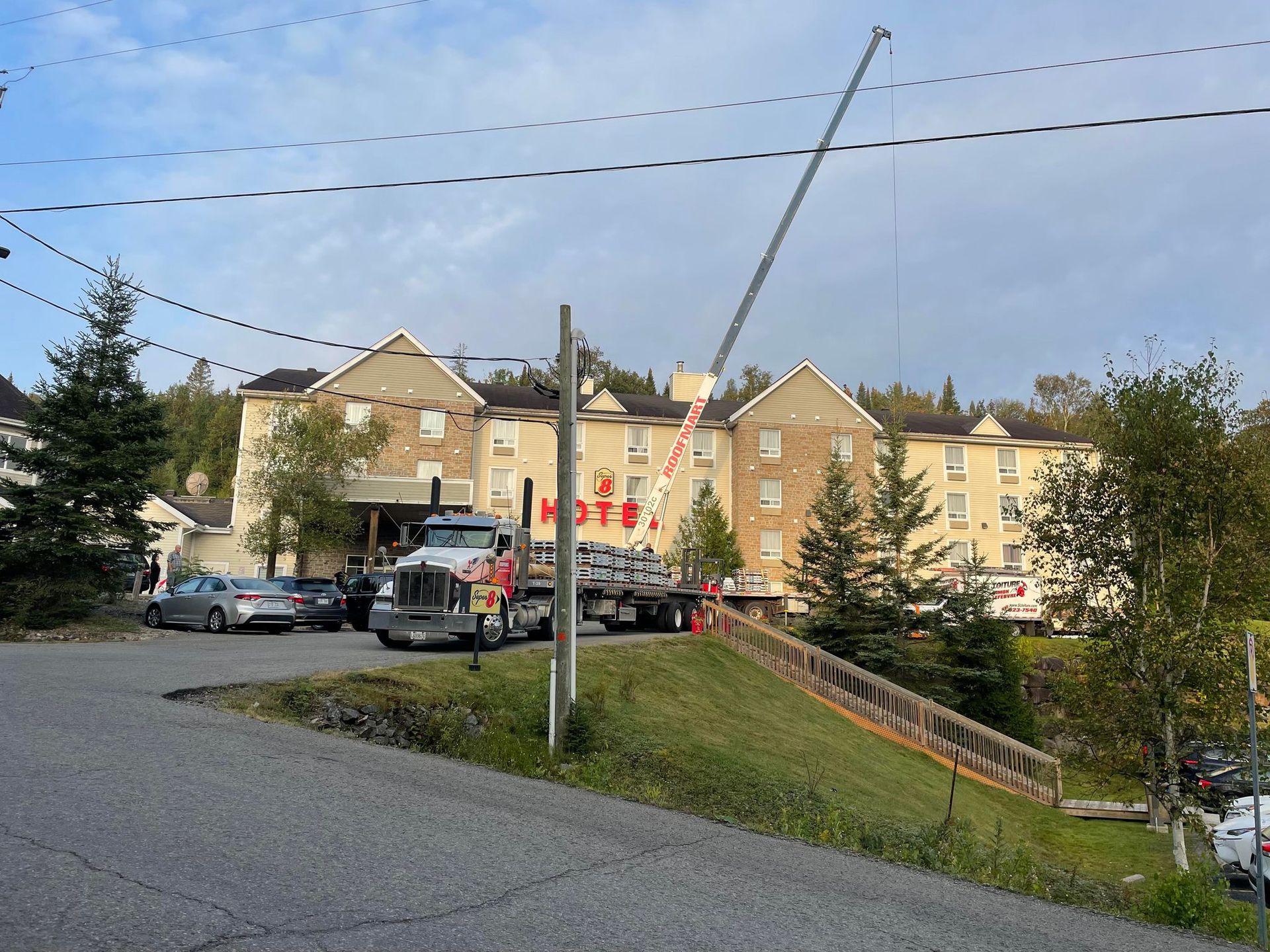A tow truck is parked in front of a large building.