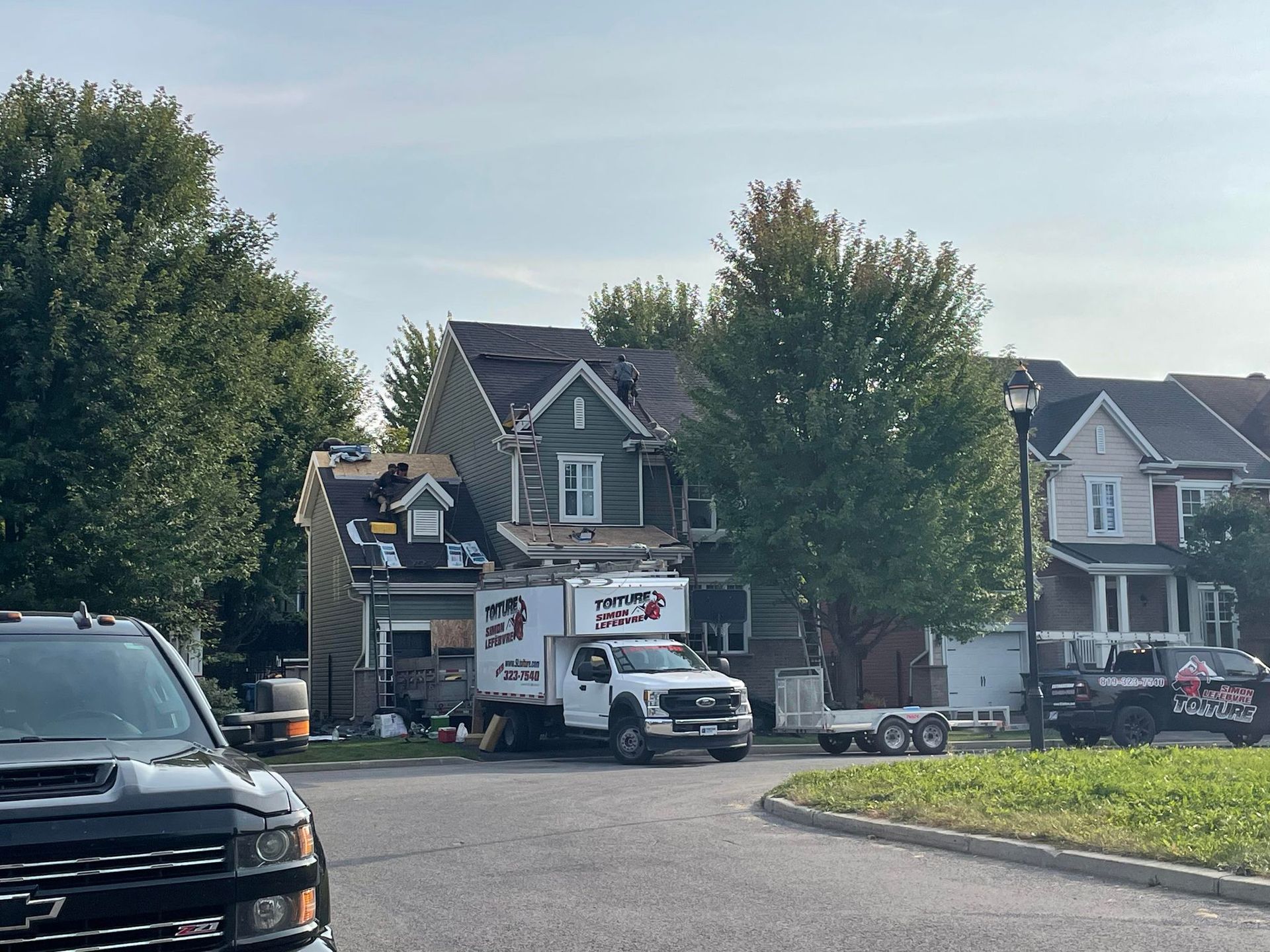 A truck is parked in front of a house that is being remodeled.