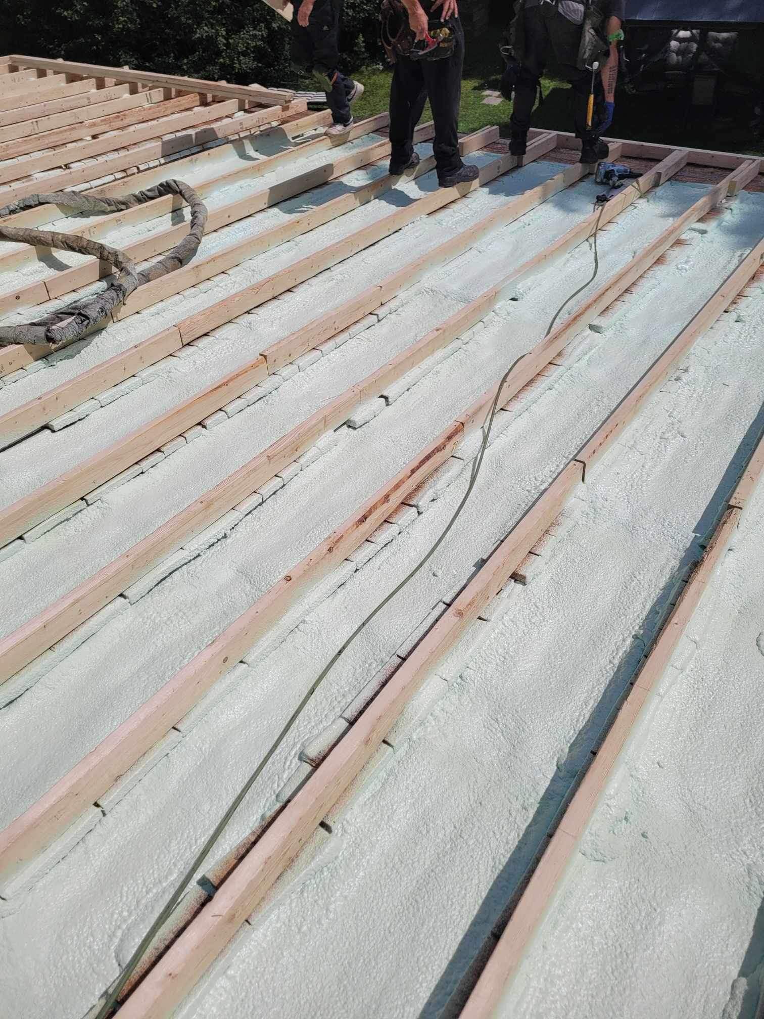 A group of construction workers are working on a roof.