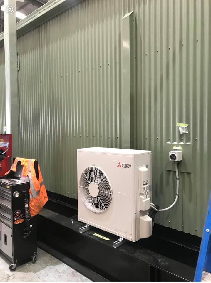 Green Metal Wall with Air-condition — Air Conditioning Port Stephens