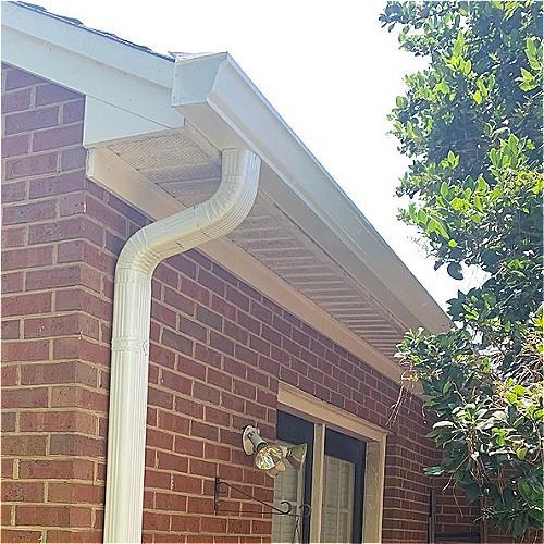 Exterior view of a screened porch with white trim and multiple windows.