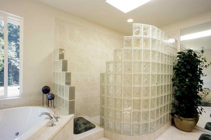 A bathroom with a tub and a walk in shower