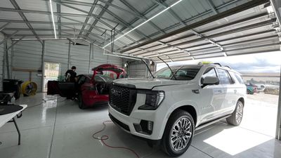 Windshield protection film installation on a GMC truck.