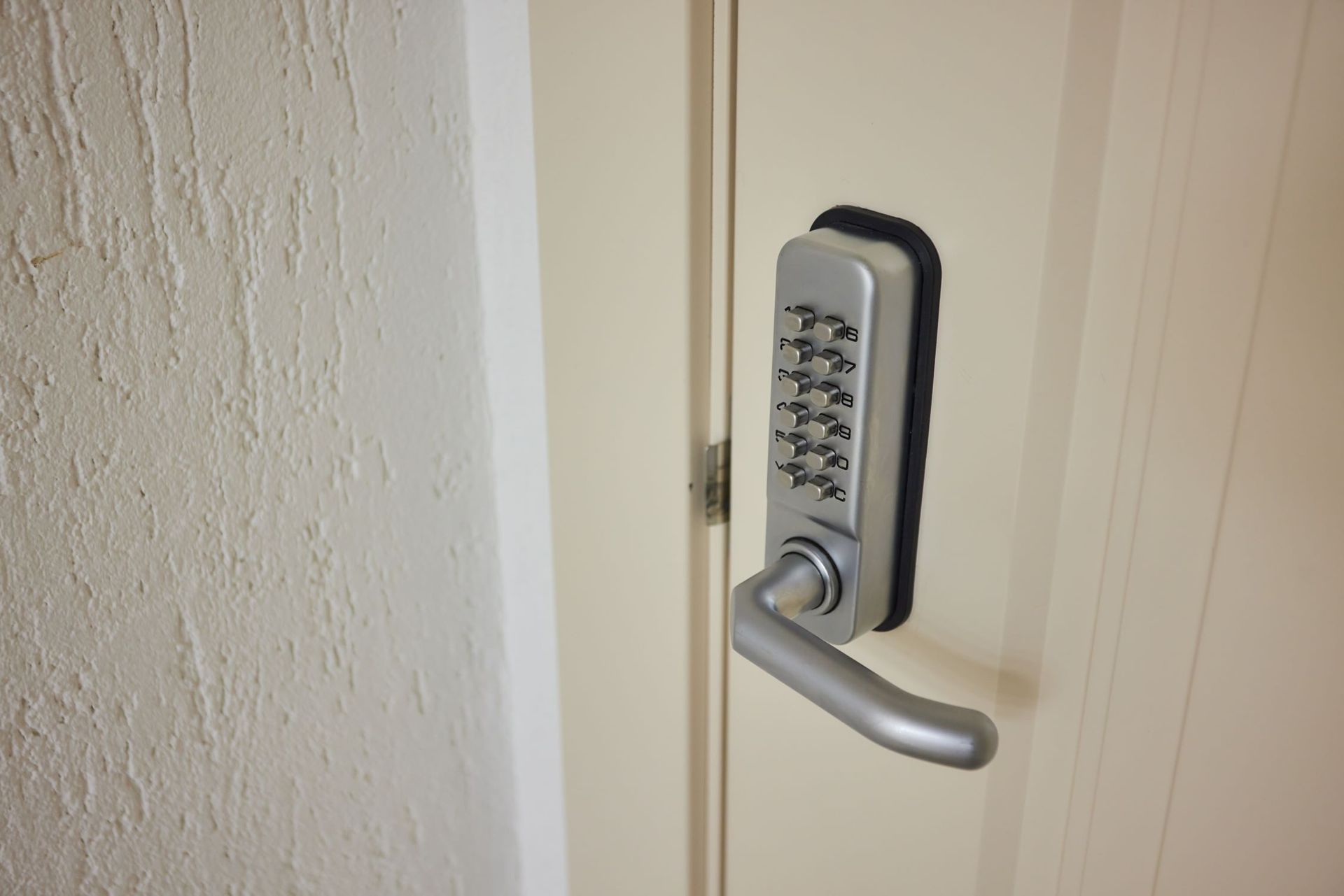 A Close Up Of A Door With A Keypad On It