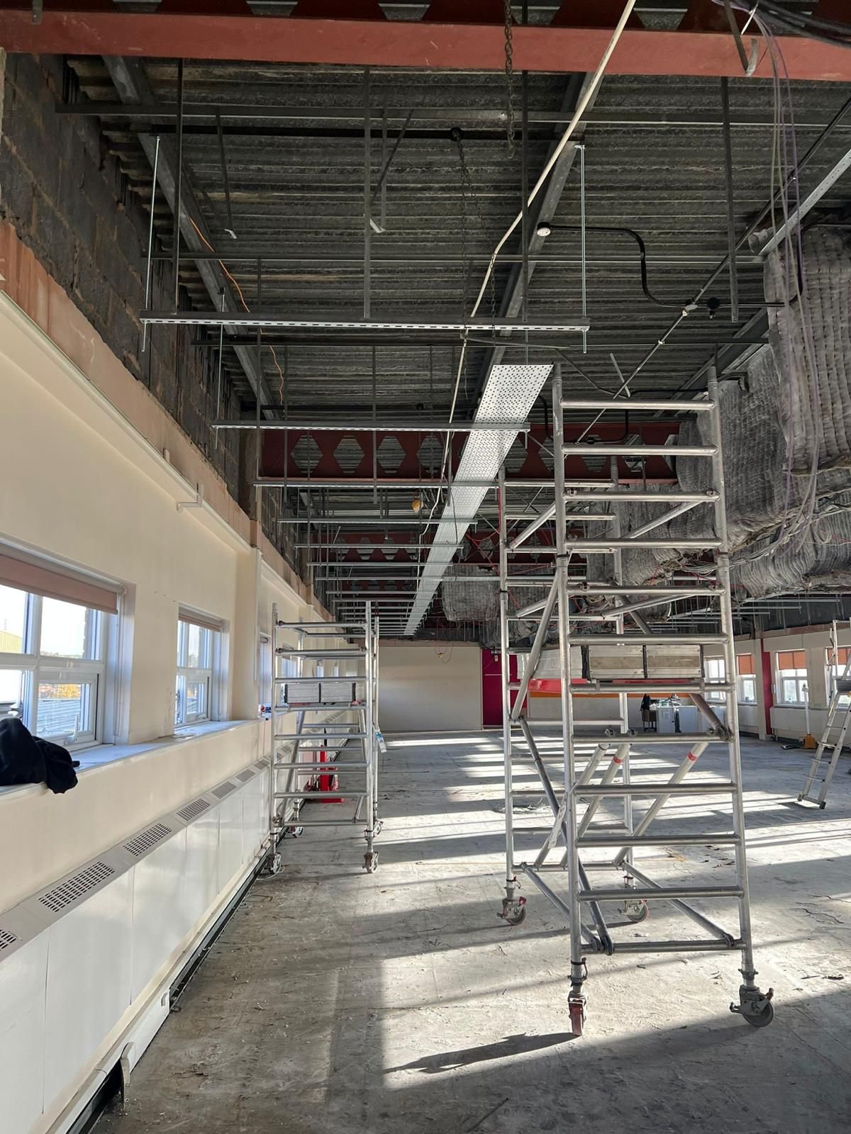 Empty construction site with scaffolding inside a building under renovation