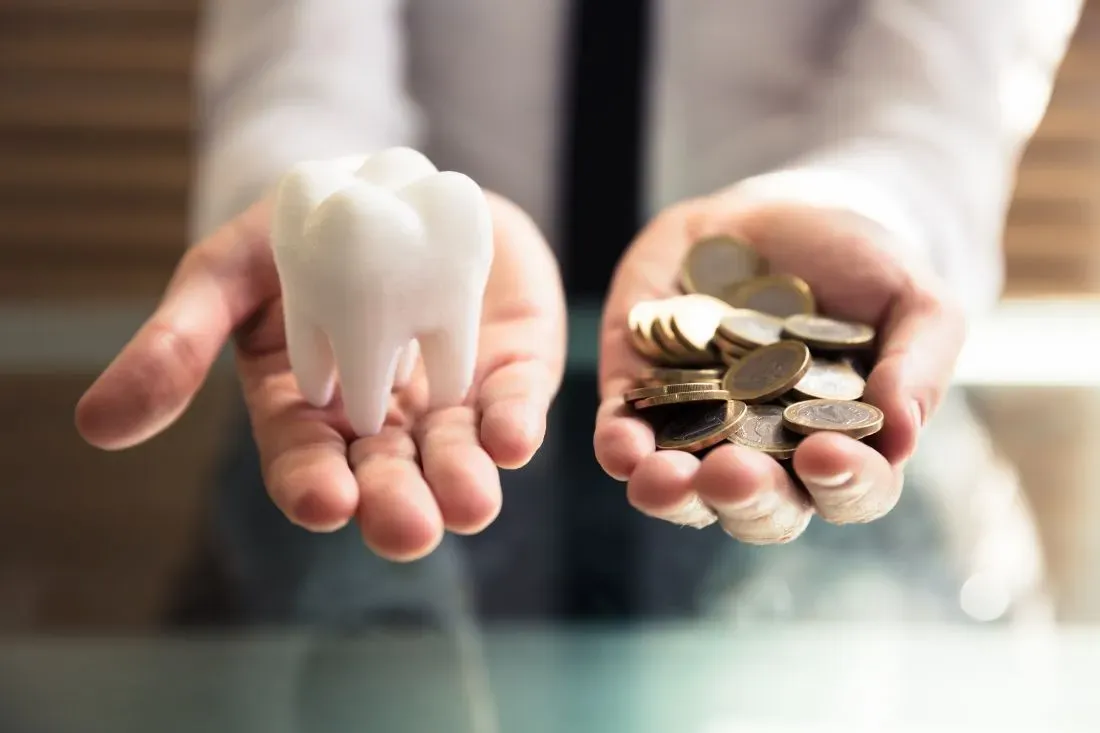 Hands Close Up In One Lies The Tooth, In The Second Coins - Atlanta, GA - Downtown Dental Center Hands Close Up In One Lies The Tooth, In The Second Coins - Atlanta, GA - Downtown Dental Center