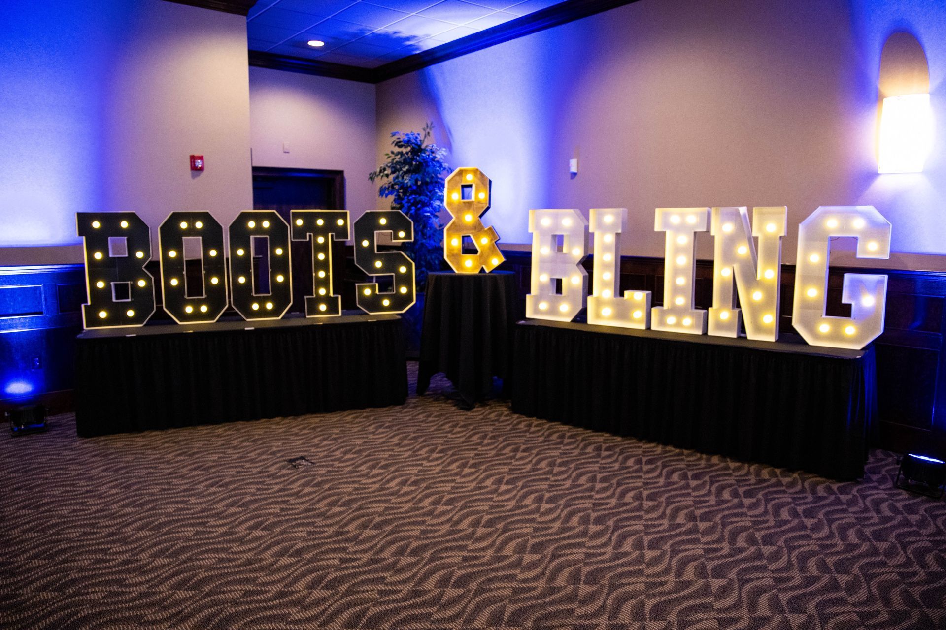 A room with a sign that says boots and bling