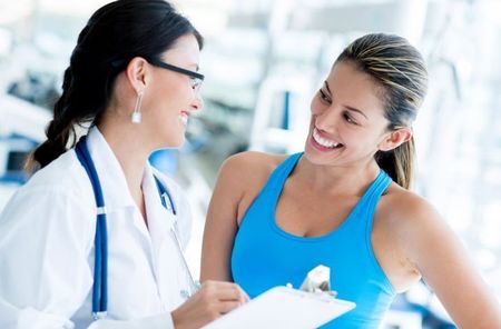 Doctor talking with a smiling patient in a bright clinic office