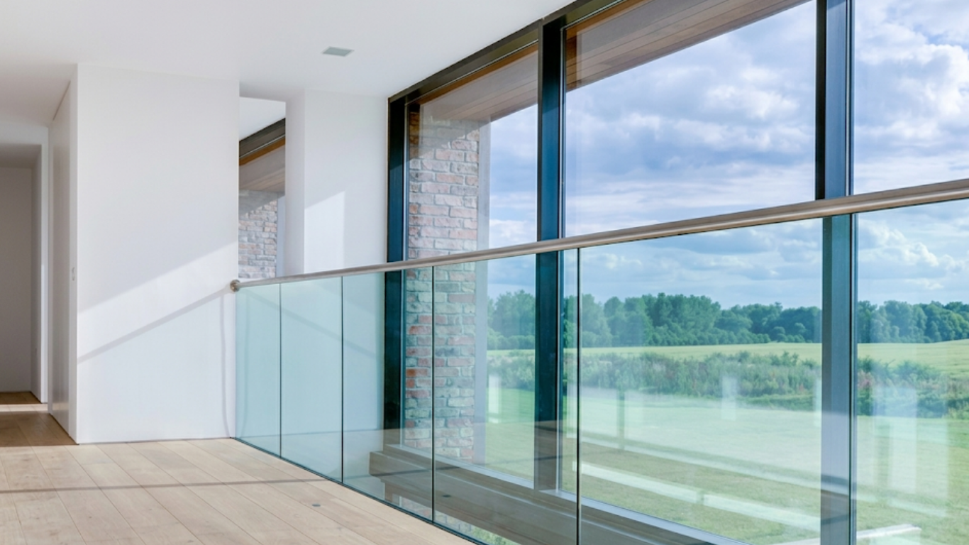 Bright modern glass corridor with white floors and ceiling lights