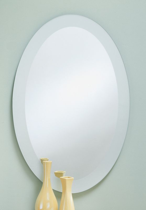 Oval wall mirror above two pale yellow vases on a light green wall