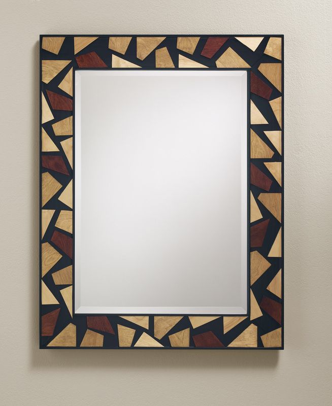 Decorative geometric photo frame with an empty white center hanging on a beige wall