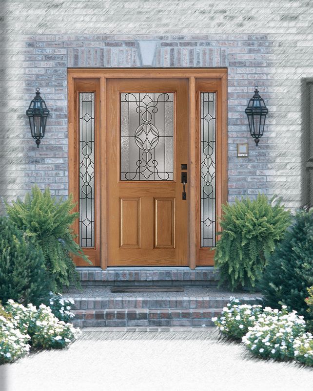 Wooden front door with decorative glass panels, flanked by lanterns and shrubs, on a stone entryway