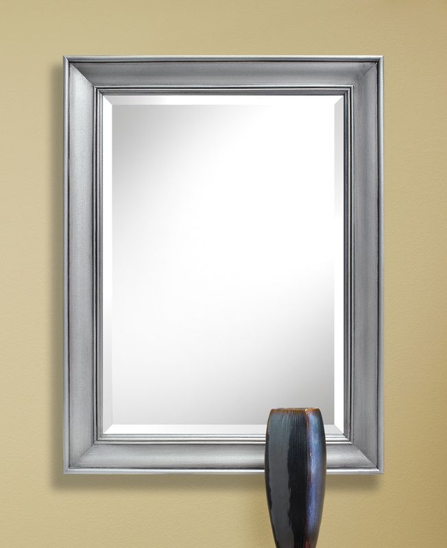 Silver-framed wall mirror with a dark handle-like object at the bottom center