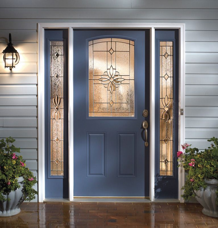 Blue front door with glass sidelights and a lantern on a white house porch