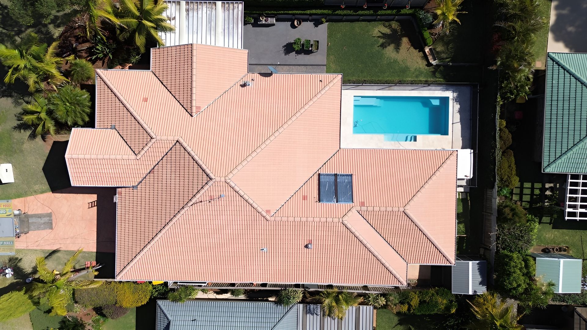 Overhead View of A House with A Pool and Terracotta Roof — Geoff Hall Roofing in Port Macquarie, NSW