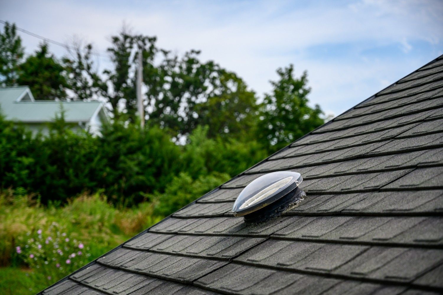 Dark Shingled Roof with A Solar Tube — Geoff Hall Roofing in Port Macquarie, NSW