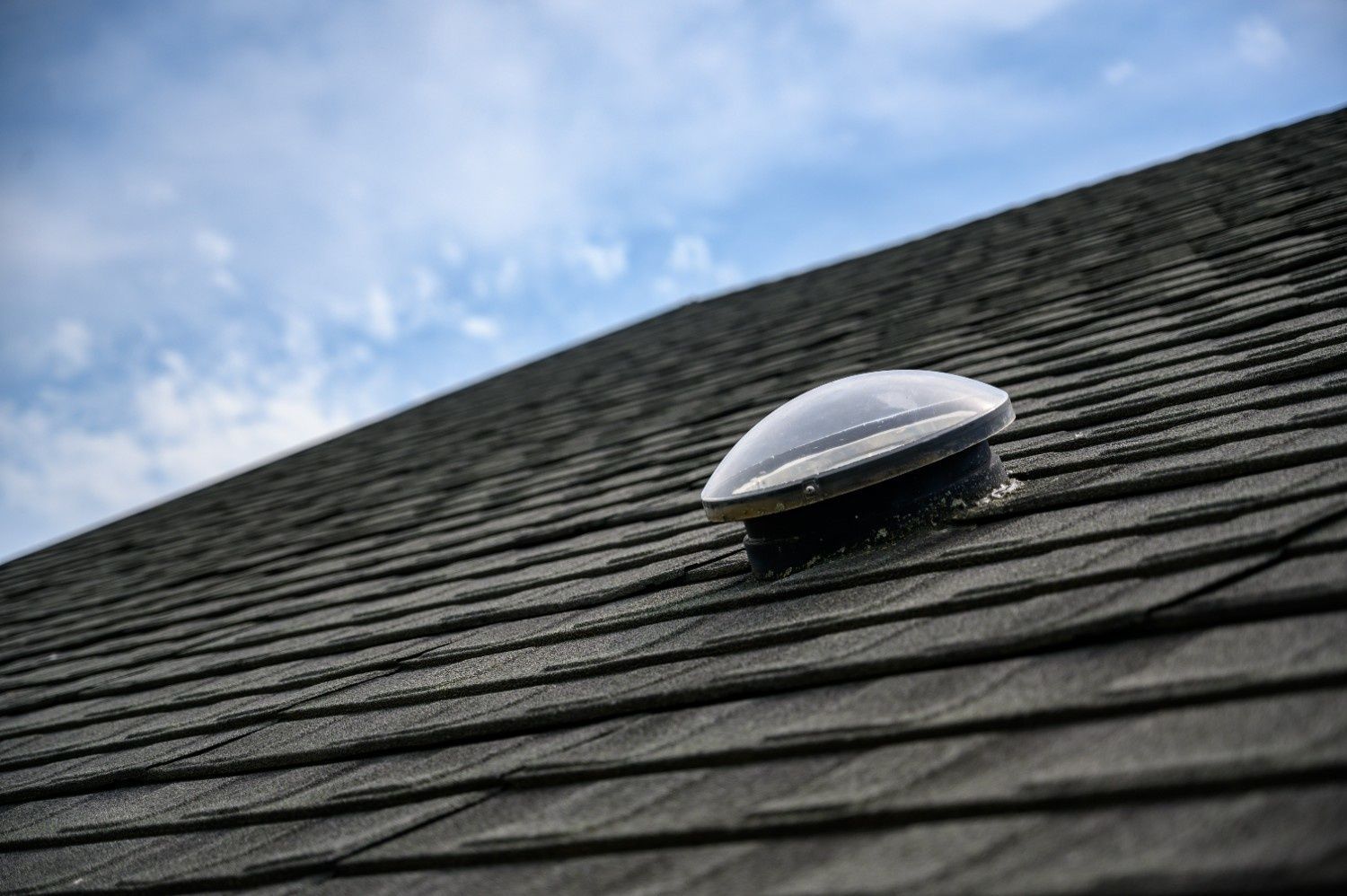 Black Shingle Roof with A Solar Tube on It — Geoff Hall Roofing in Port Macquarie, NSW