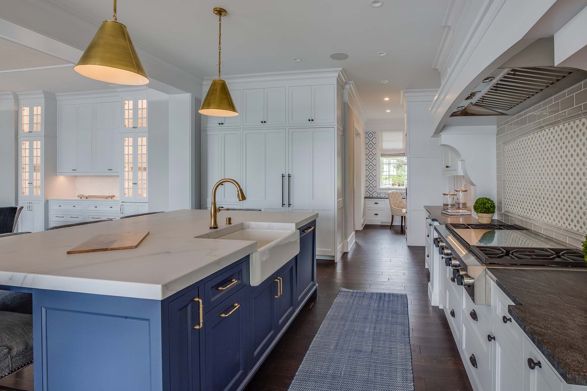 A kitchen with blue cabinets and white cabinets and a large island